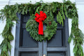 Commercial Christmas wreath installation for a Des Moines office building entrance - Front Porch Collective