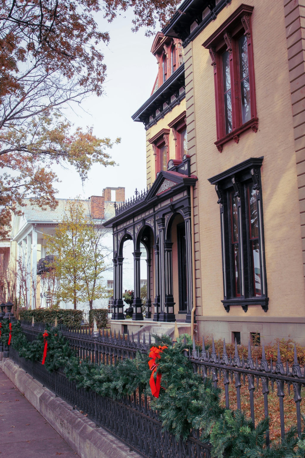 Holiday garland installation for a Sherman Hill historic building in Des Moines - Front Porch Collective