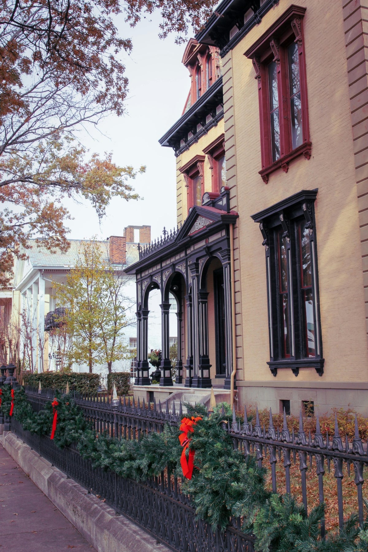 Holiday garland installation for a Sherman Hill historic building in Des Moines - Front Porch Collective